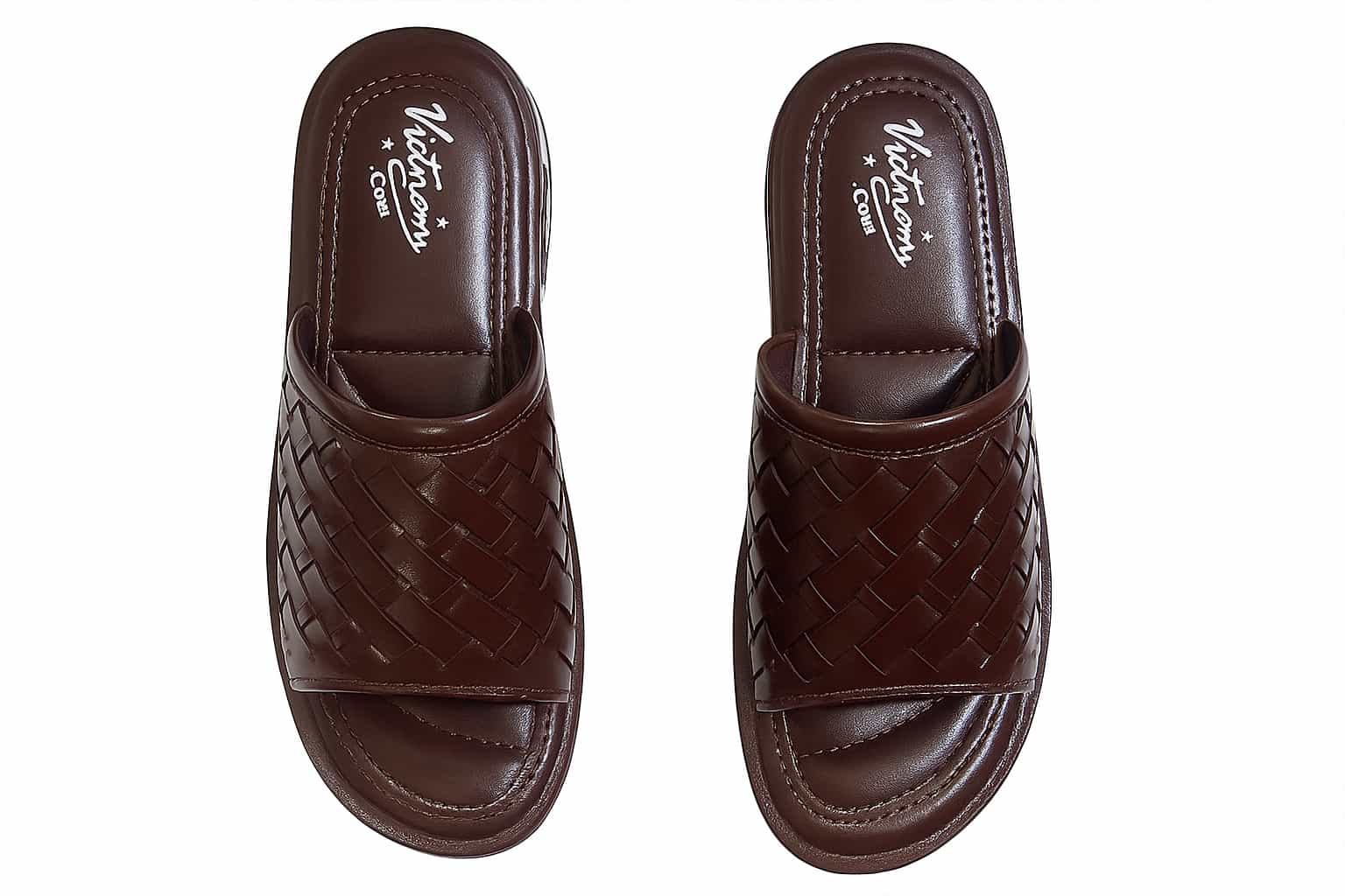 Pair of brown woven slippers on a white background
