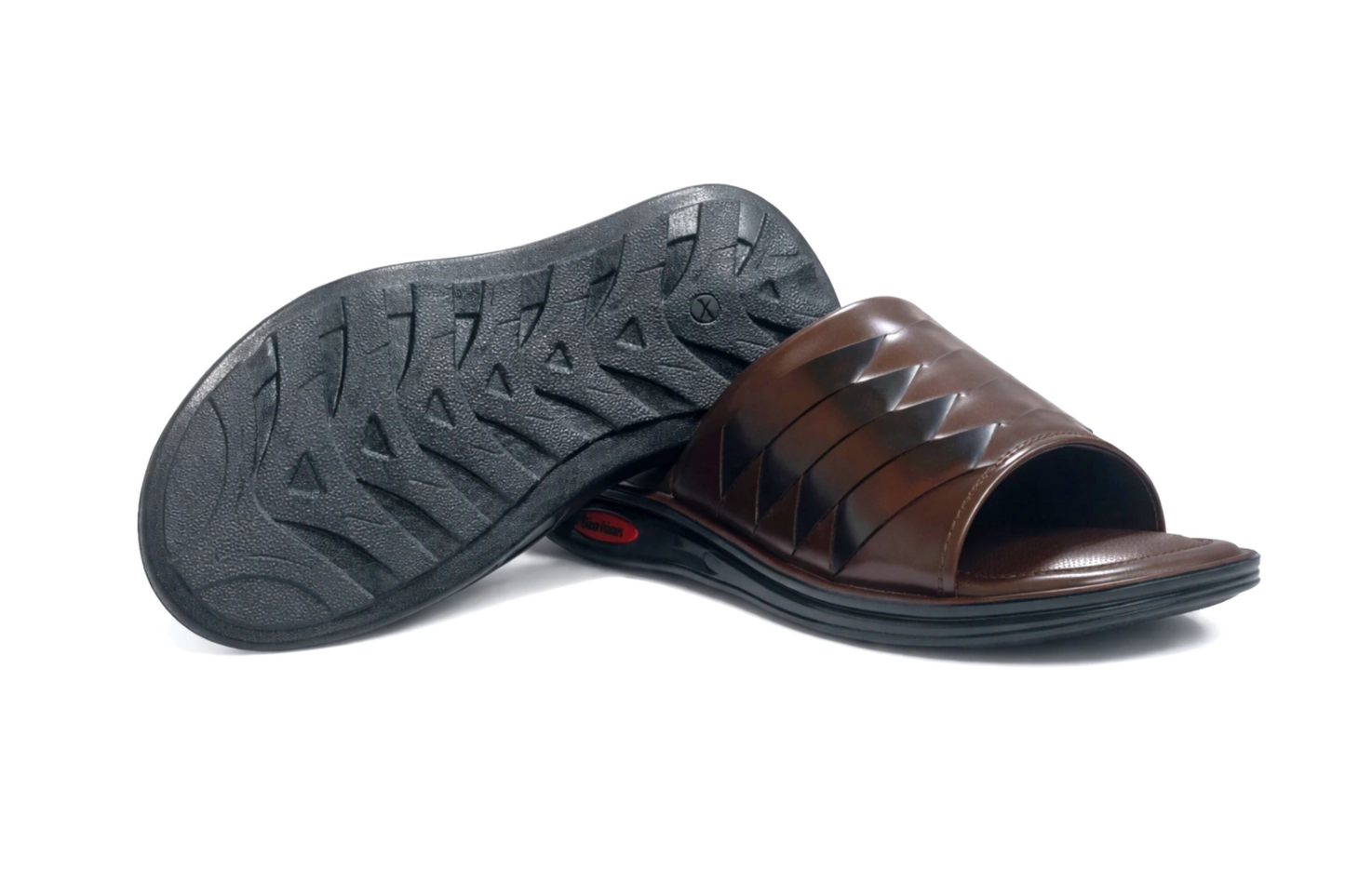 Brown slipper with textured sole on a white background