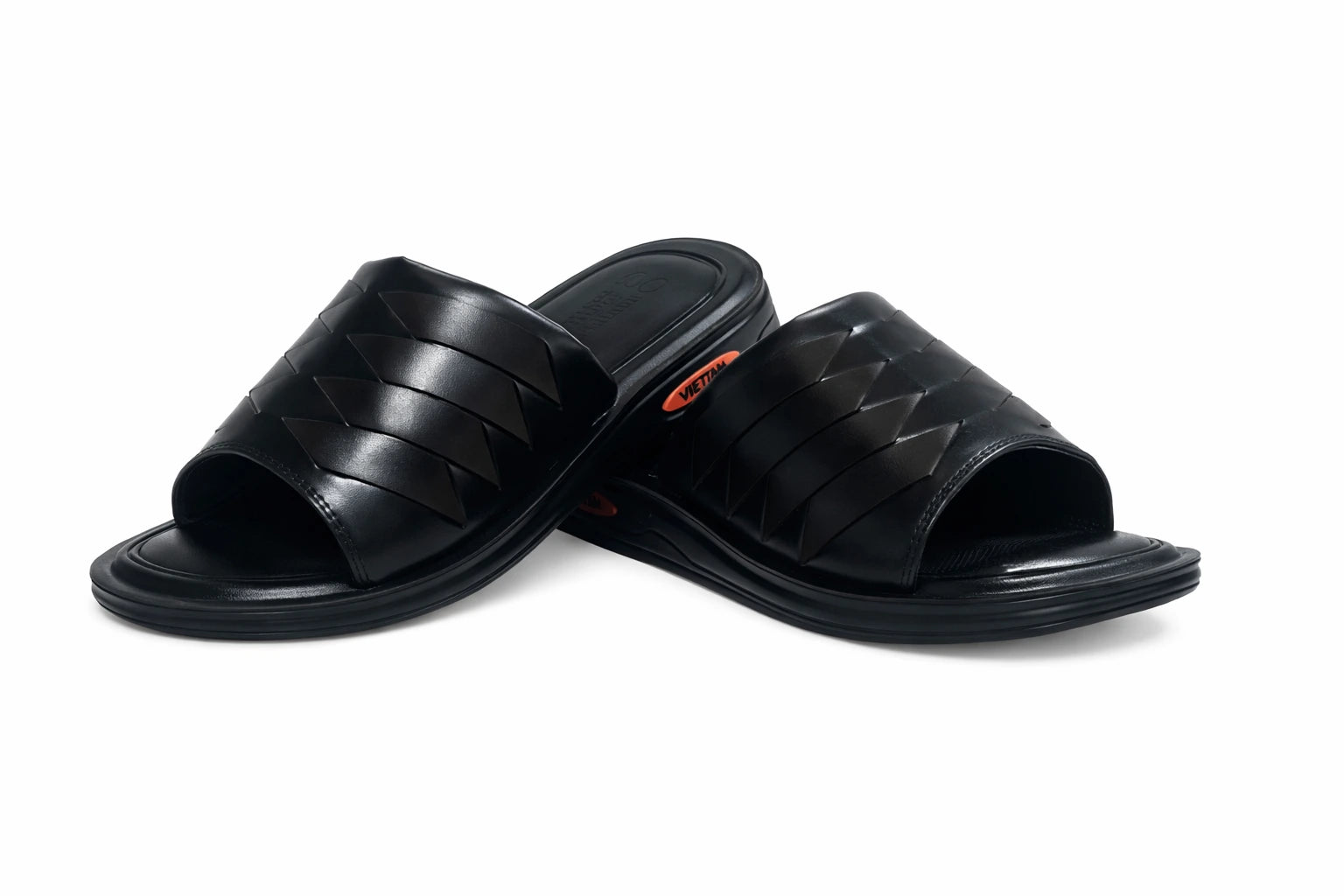 Pair of black slippers on a white background