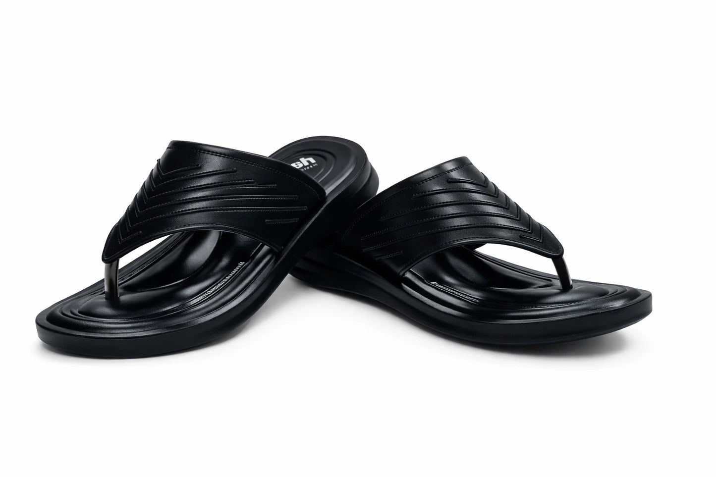 Pair of black slippers on a white background