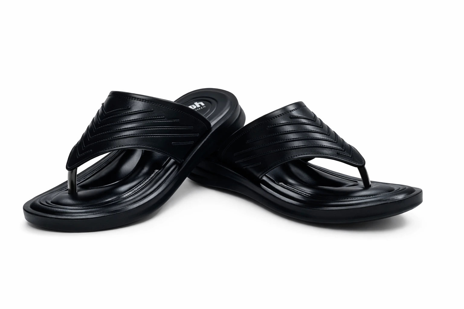 Pair of black slippers on a white background